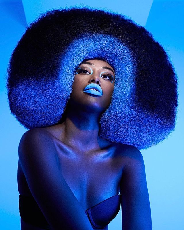 Sculpted textured hair on blue backdrop